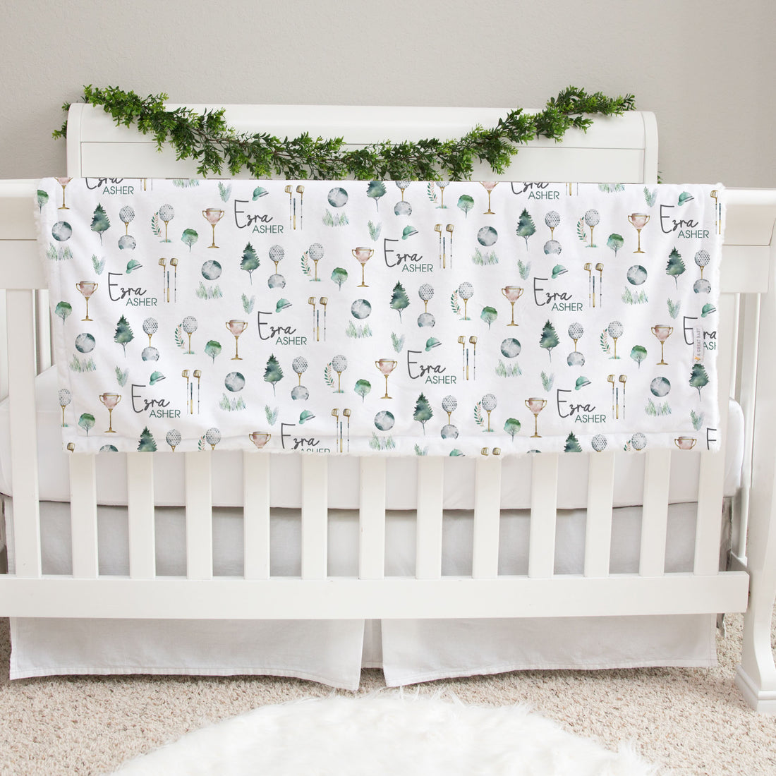 Soft and plush minky and fur baby blanket with a white background, luxurious green fur, adorned with a golf-themed print, and personalized custom details
