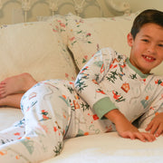 Young boy laying down wearing Ski Pajamas. 