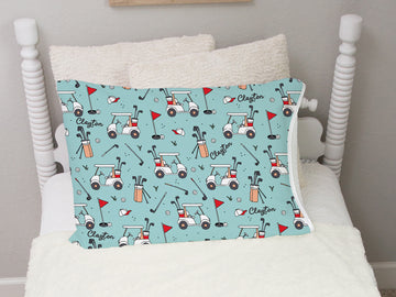 personalize minky pillowcase for kids with a teal background, gofling images such as a golf cart, flats, club bag, and kid's name in black cursive font scattered around.