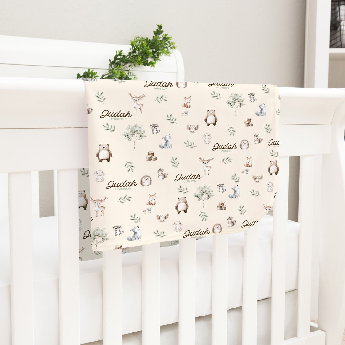 gender neutral woodland animal satin bound baby blanket personalized with babys name on an ivory background