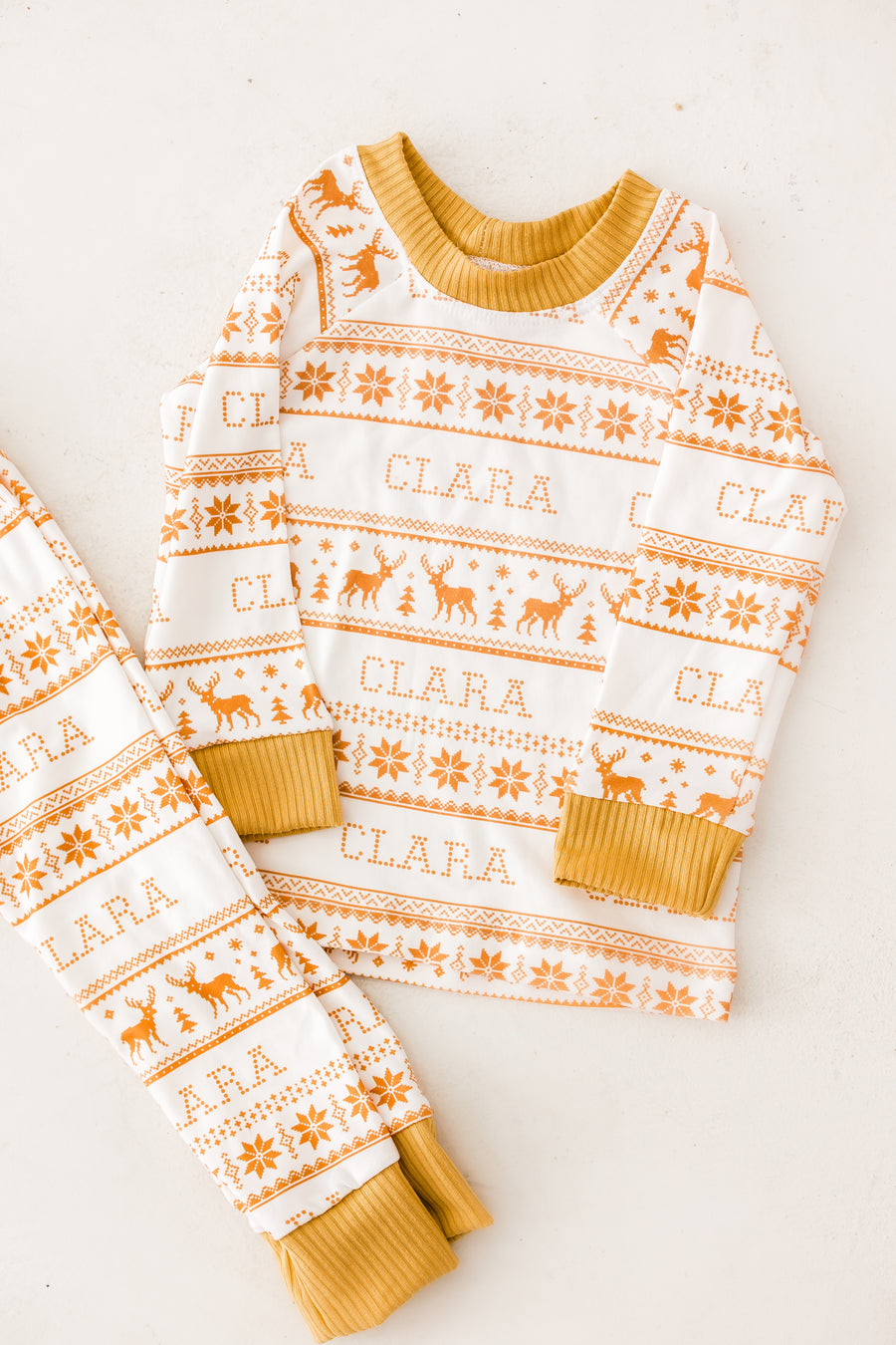 Yellow striped Christmas pajamas design that are personalized with a child's name