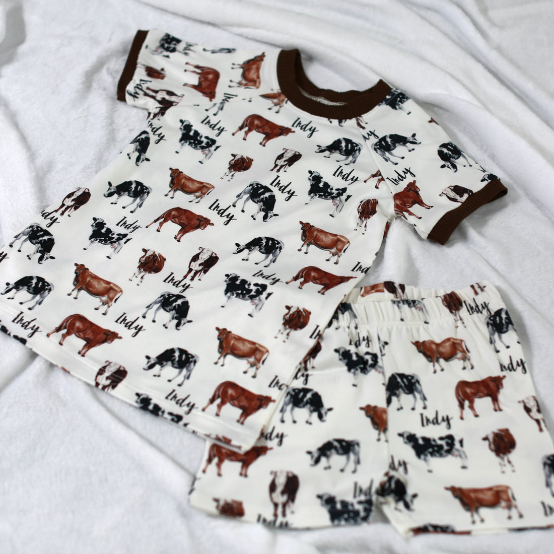 Our personalized cow pajamas top and shorts. The pajama top and shorts have a matching design with three different colored cows.