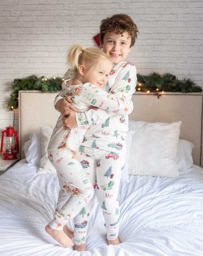 A brother and sister wearing matching Gingerbread Christmas Pajamas. 